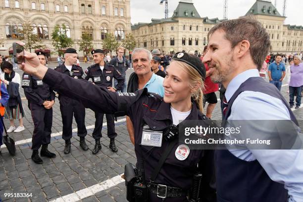 Gareth Southgate lookalike Neil Rowe poses for a selfie with a tourist police officer as he causes a stir as football fans, TV crews and tourists...