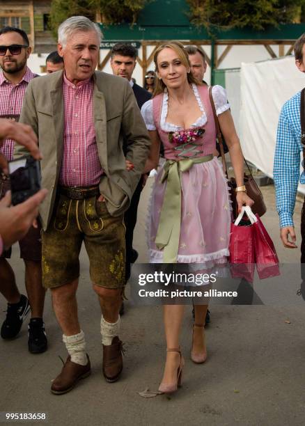 Head coach Carlo Ancelotti of FC Bayern Munich arrives at the "Kaeferzelt" tent with his wife Mariann Barrena McClay at the Theresienwiese in Munich,...