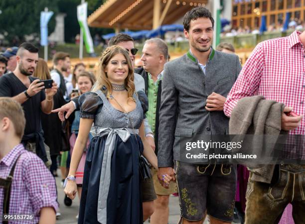 Head coach Carlo Ancelotti of FC Bayern Munich arrives at the "Kaeferzelt" tent with his wife Mariann Barrena McClay at the Theresienwiese in Munich,...