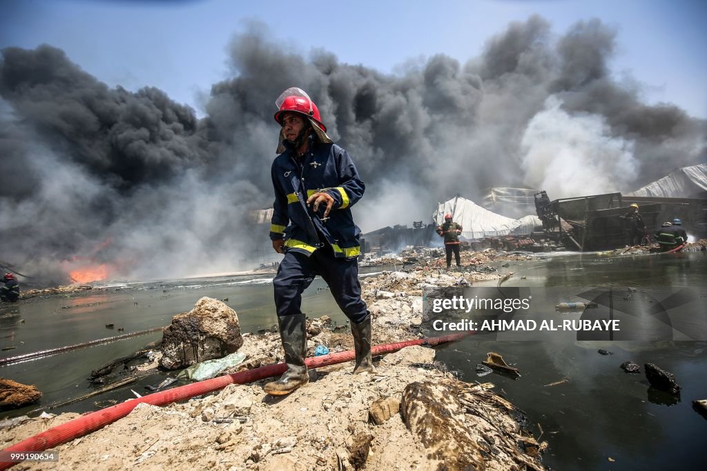 Iraq Fire Engine An Iraqi firefighter walks past a hose during a fire that broke out ...