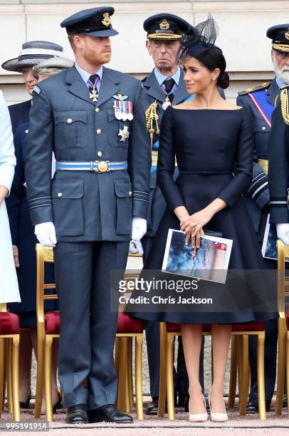 Prince Harry, Duke of Sussex and Meghan, Duchess of Sussex during the RAF 100 ceremony at Buckingham Palace, as members of the Royal Family attend...