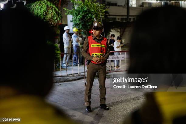 Police officer guards the hospital entrance before ambulances carrying some of the remaining schoolboys arrives at Chiangrai Prachanukroh Hospital on...