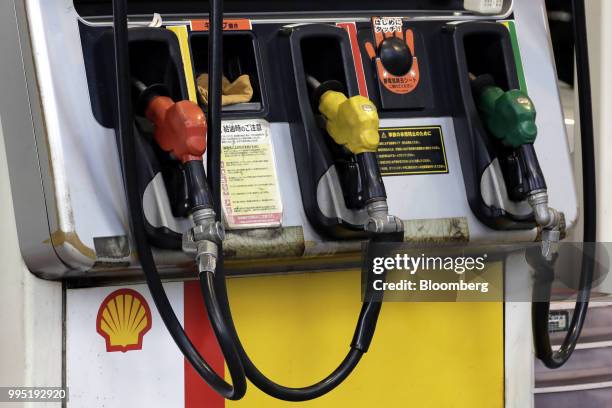 Fuel pump nozzles sit at a Showa Shell Sekiyu K.K. Gasoline station in Tokyo, Japan, on Tuesday, July 10, 2018. Showa Shell and Idemitsu Kosan Co....