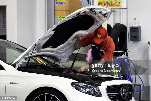 An attendant works on a customer's vehicle at a Showa Shell Sekiyu K.K. Gasoline station in Tokyo, Japan, on Tuesday, July 10, 2018. Showa Shell and...