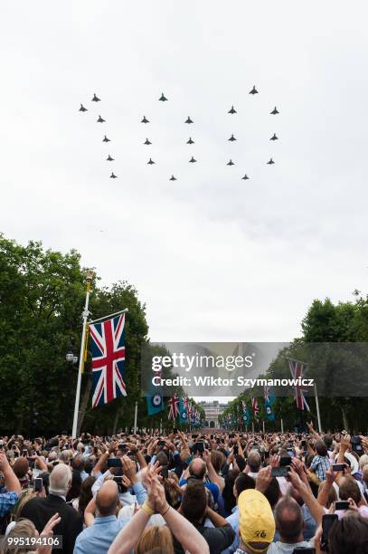 Tens of thousands of spectators gathered along The Mall in central London to watch a flypast of Typhoon fighter jets forming number 100 to celebrate...