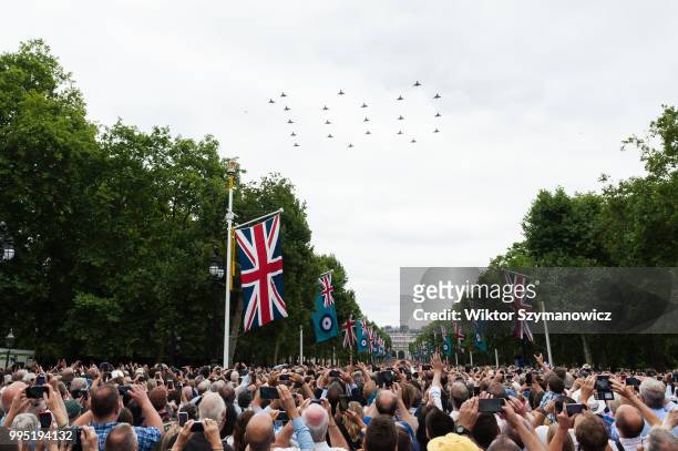 Tens of thousands of spectators gathered along The Mall in central London to watch a flypast of Typhoon fighter jets forming number 100 to celebrate...