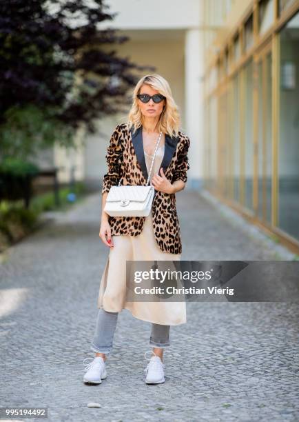 Gitta Banko wearing a velvet blazer with leopard print by Jadicted, beige silk dress by Anine Bing, light-grey Jeans by True Religion, white Chanel...