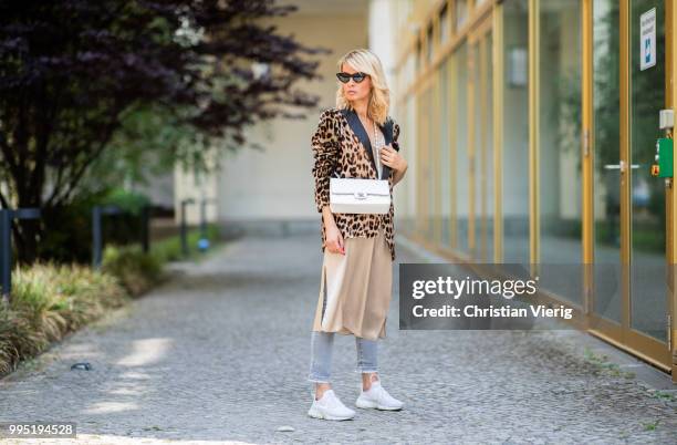 Gitta Banko wearing a velvet blazer with leopard print by Jadicted, beige silk dress by Anine Bing, light-grey Jeans by True Religion, white Chanel...