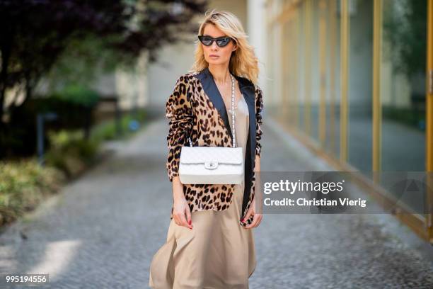 Gitta Banko wearing a velvet blazer with leopard print by Jadicted, beige silk dress by Anine Bing, light-grey Jeans by True Religion, white Chanel...