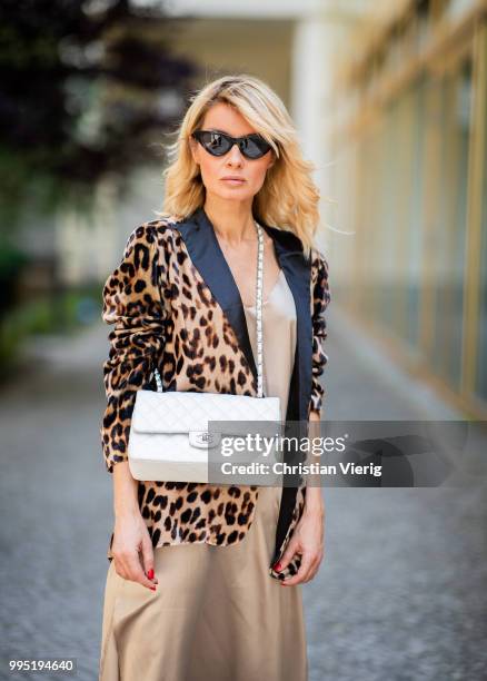 Gitta Banko wearing a velvet blazer with leopard print by Jadicted, beige silk dress by Anine Bing, light-grey Jeans by True Religion, white Chanel...