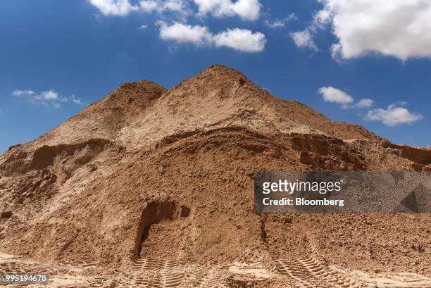 Pile of sand stands at the Hi-Crush Partners LP mining facility in Kermit, Texas, U.S., on Wednesday, June 20, 2018. In the West Texas plains,...