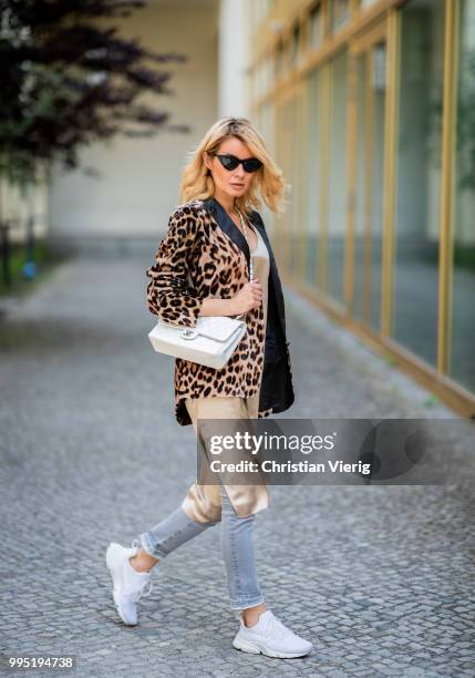 Gitta Banko wearing a velvet blazer with leopard print by Jadicted, beige silk dress by Anine Bing, light-grey Jeans by True Religion, white Chanel...