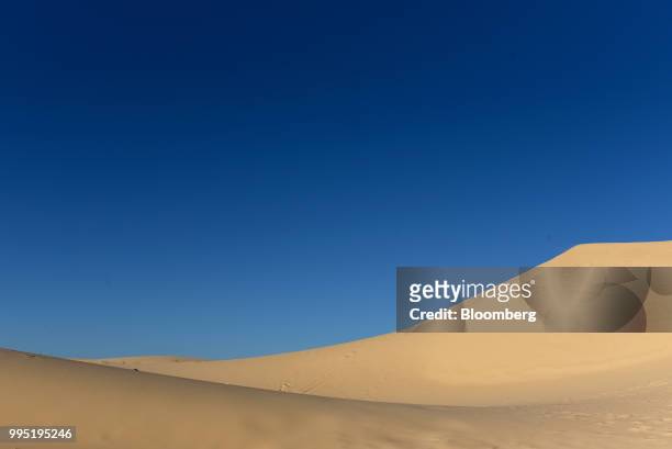 Sand dune stands at Monahans Sandhills State Park in Monahans, Texas, U.S., on Tuesday, June 19, 2018. In the West Texas plains, frack-sand mines...