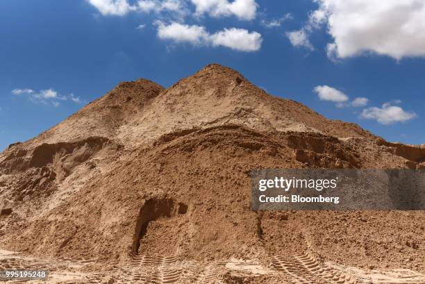 Pile of sand stands at the Hi-Crush Partners LP mining facility in Kermit, Texas, U.S., on Wednesday, June 20, 2018. In the West Texas plains,...