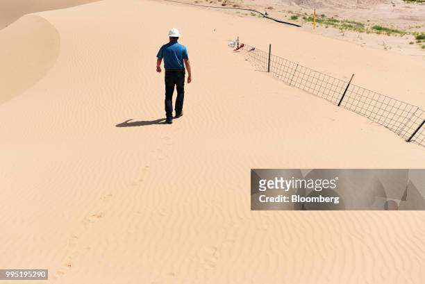 Greg Edwards, manager for Hi-Crush Partners LP, walks through the sand dunes in Kermit, Texas, U.S., on Wednesday, June 20, 2018. In the West Texas...