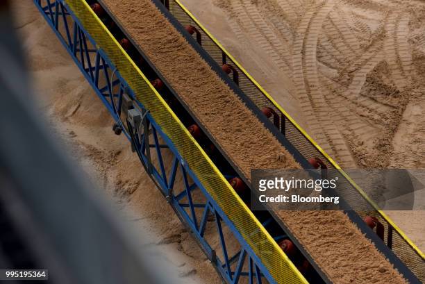Sand moves along a conveyor belt at the Hi-Crush Partners LP mining facility in Kermit, Texas, U.S., on Wednesday, June 20, 2018. In the West Texas...