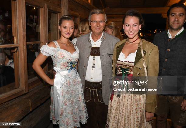 The CDU politician Wolfgang Bosbach and his daughters Viktoria and Caroline can be seen at the Kaefer Tent at the Bavarian Oktoberfest in Munich,...