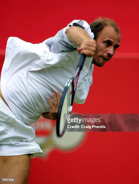 Jens Knippschild of Germany in action against Marat Safin of Russia during the second round of the Stella Artois Championships at Queen's Club,...