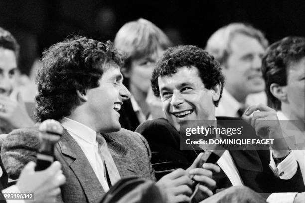 Photo taken on May 2, 1984 shows French football player Michel Platini laughing with French actor Francis Perrin during a TV show.