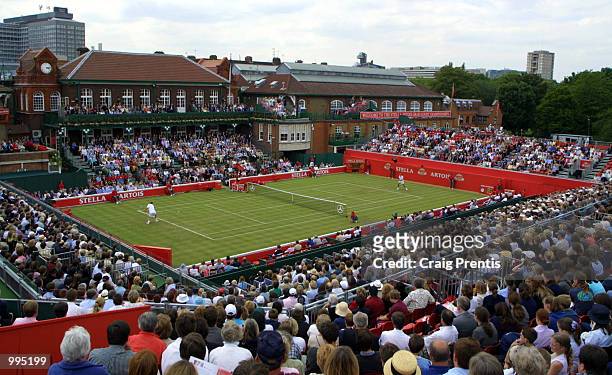 The full house watch number one seed Marat Safin of Russia take on Jens Knippschild of Germany during the second round of the Stella Artois...