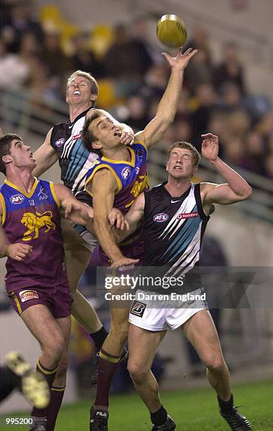 Daniel Bradshaw of Brisbane tries to mark over the top of Nick Stevens and Stephen Paxman of Port Adelaide during the AFL round 16 match between the...