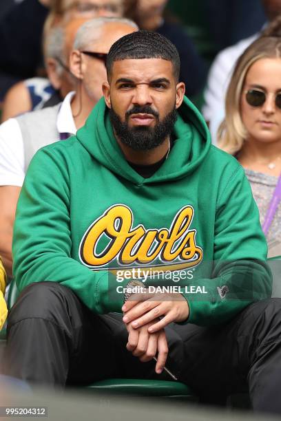 Rapper Drake sits on Centre Court before US player Serena Williams plays against Italy's Camila Giorgi during their women's singles quarter-final...