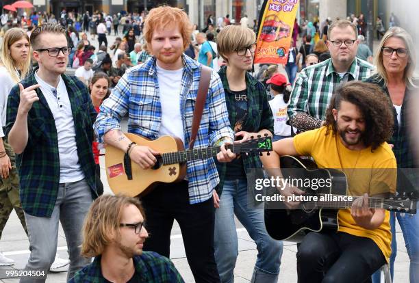 June 2018, Germany, Berlin: A wax figure by the British singer Ed Sheeran from the wax museum Madame Tussauds is displayed on Alexanderplatz. The...