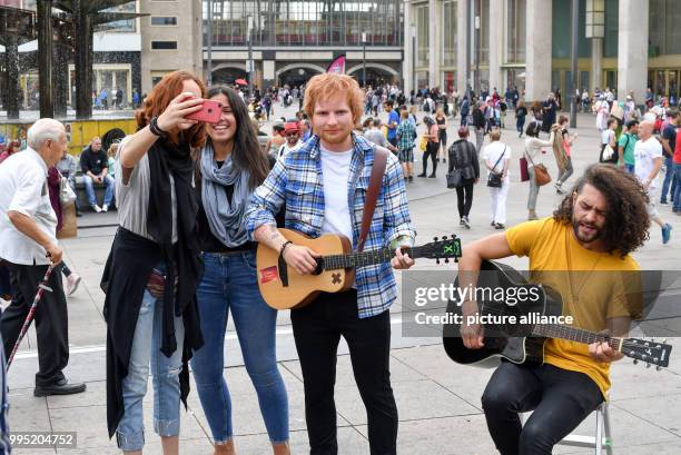 June 2018, Germany, Berlin: A wax figure by the British singer Ed Sheeran from the wax museum Madame Tussauds is displayed on Alexanderplatz. The...