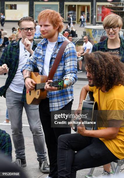 June 2018, Germany, Berlin: A wax figure by the British singer Ed Sheeran from the wax museum Madame Tussauds is displayed on Alexanderplatz. The...