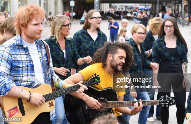 June 2018, Germany, Berlin: A wax figure by the British singer Ed Sheeran from the wax museum Madame Tussauds is displayed on Alexanderplatz. The...