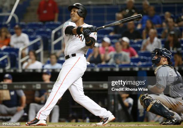 Starlin Castro of the Miami Marlins hits a home run during the game against the Milwaukee Brewers at Marlins Park on Monday, July 9, 2018 in Miami,...