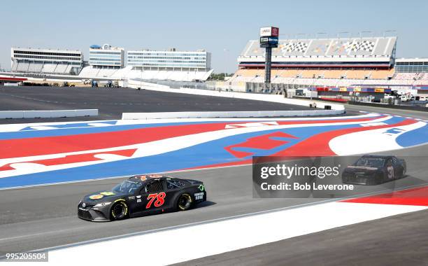 Martin Truex, Jr. Steers the 78 Toyota ahead of Ryan Newman's during testing at The Roval at Charlotte Motor Speedway on July 10, 2018 in Charlotte,...