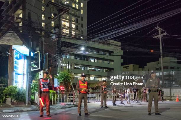 July 10: Policeman standby the junction leading to Chiangrai Prachanukroh Hospital where 12 rescued boys and their coach are kept on July 10, 2018 in...
