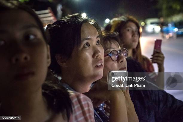 July 10: Onlookers at the junction in front of Chiangrai Prachanukroh Hospital watch and cheer as ambulances transport the last rescued schoolboys...