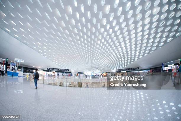 unidentified passenger walking in modern shenzhen  airport,china - yaorusheng stock pictures, royalty-free photos & images