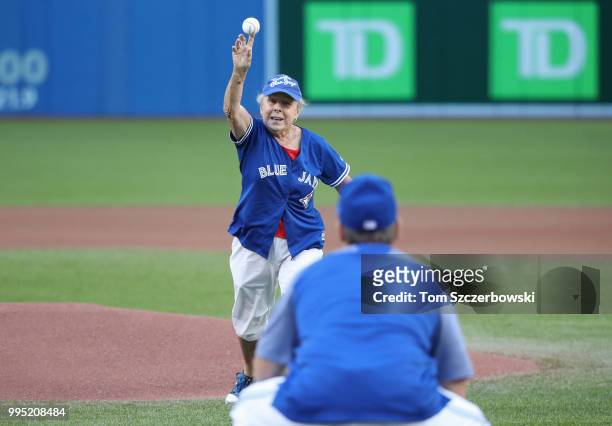 Sallie Gibbons the mother of manager John Gibbons of the Toronto Blue Jays throws out the first pitch to her son before the start of MLB game action...