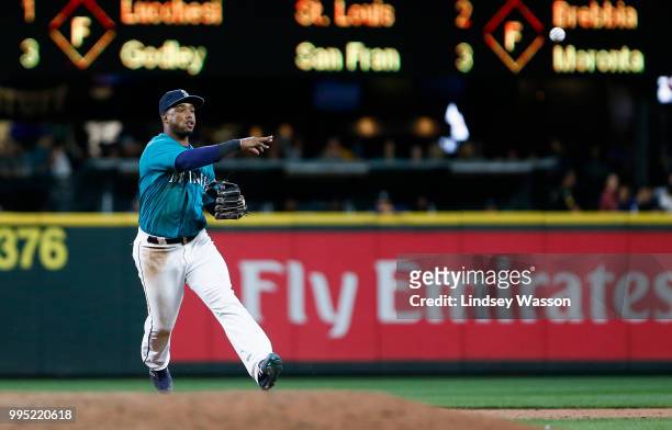 Jean Segura of the Seattle Mariners throws to first to force out Raimel Tapia of the Colorado Rockies in the eighth inning at Safeco Field on July 6,...