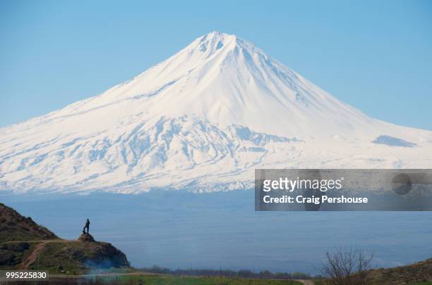 snow-covered mt ararat towers above the countryside and statue of kevuk chavush. - dormant volcano stock pictures, royalty-free photos & images