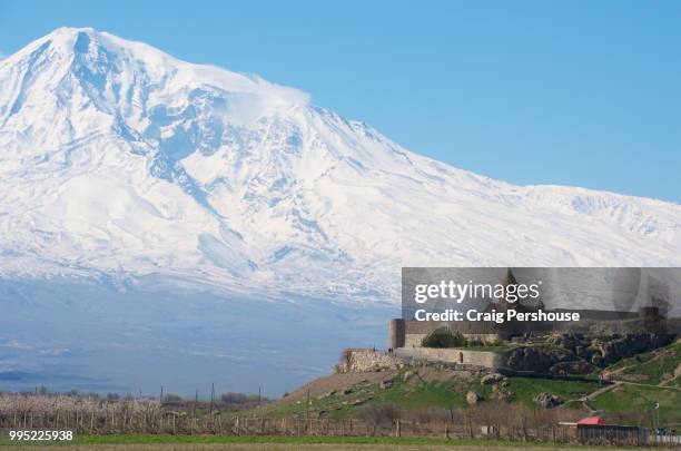 snow-covered mt ararat towers above khor virap monastery. - dormant volcano stock pictures, royalty-free photos & images