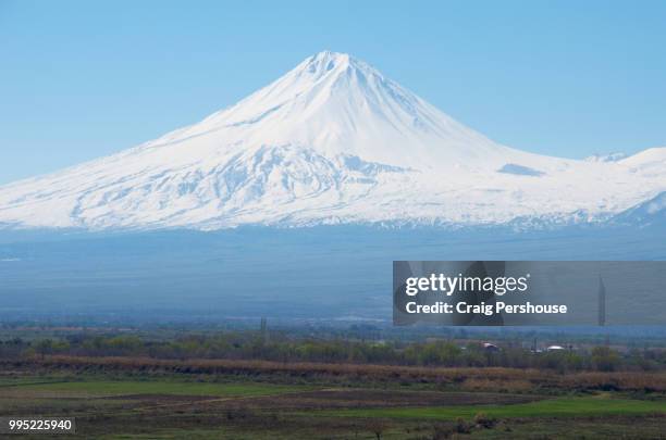 snow-covered little ararat towers above farmland. - mt ararat stock pictures, royalty-free photos & images