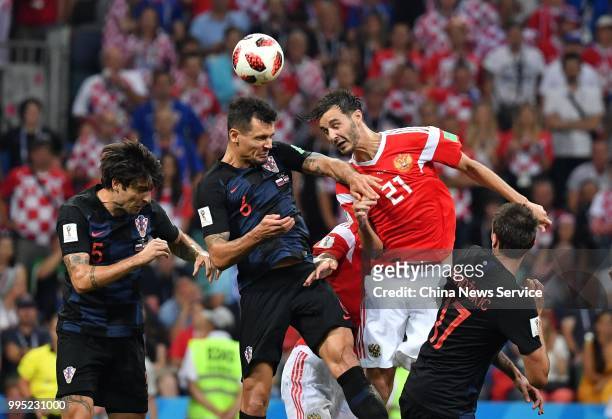 Dejan Lovren of Croatia and Aleksandr Yerokhin of Russia jump to head the ball during the 2018 FIFA World Cup Russia Quarter Final match between...