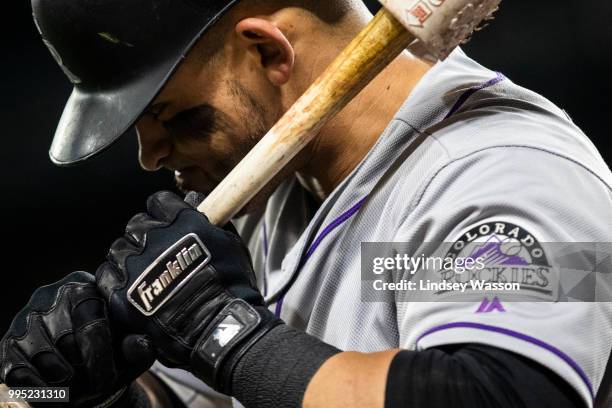 Gerardo Parra of the Colorado Rockies wears Franklin batting gloves as he warms up on deck in the ninth inning against the Seattle Mariners at Safeco...