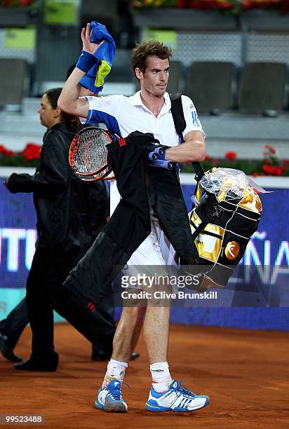 Andy Murray of Great Britain shows his dejection as he walks off the court after a straight sets defeat by David Ferrer of Spain in their quarter...