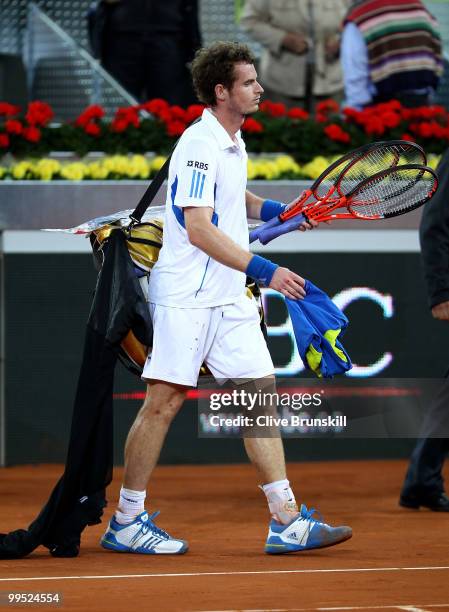 Andy Murray of Great Britain shows his dejection as he walks off the court after a straight sets defeat by David Ferrer of Spain in their quarter...