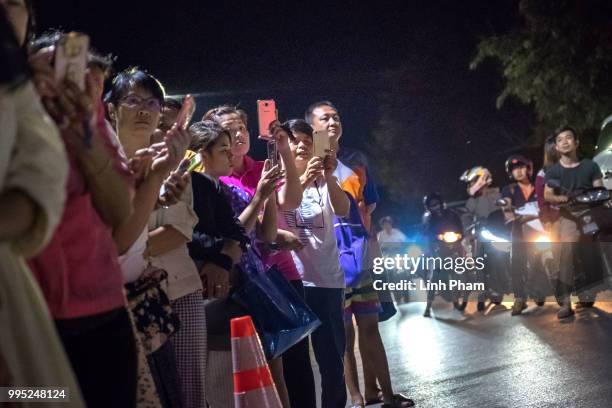 July 10: Onlookers at the junction in front of Chiangrai Prachanukroh Hospital watch and cheer as ambulances transport the last rescued schoolboys...
