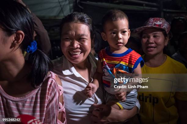 July 10: Onlookers at the junction in front of Chiangrai Prachanukroh Hospital watch and cheer as ambulances transport the last rescued schoolboys...