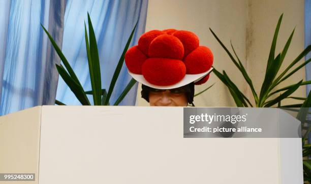 Dpatop - Corinna Woehrle casts her vote at a polling station wearing traditional Black forest festive dress for the German Federal Election in...