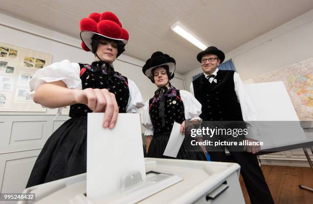 Klaus and Gabriele Lauble , as well as Corinna Woehrle cast their votes at a polling station wearing traditional Black forest festive dress for the...