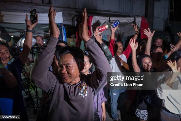 July 10: Onlookers at the junction in front of Chiangrai Prachanukroh Hospital watch and cheer as ambulances transport the last rescued schoolboys...