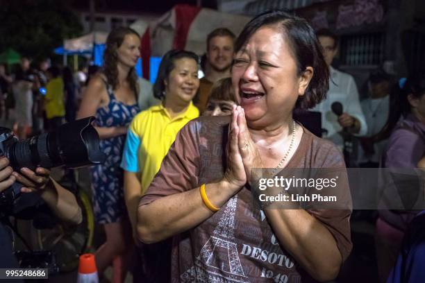 July 10: Onlookers at the junction in front of Chiangrai Prachanukroh Hospital watch and cheer as ambulances transport the last rescued schoolboys...